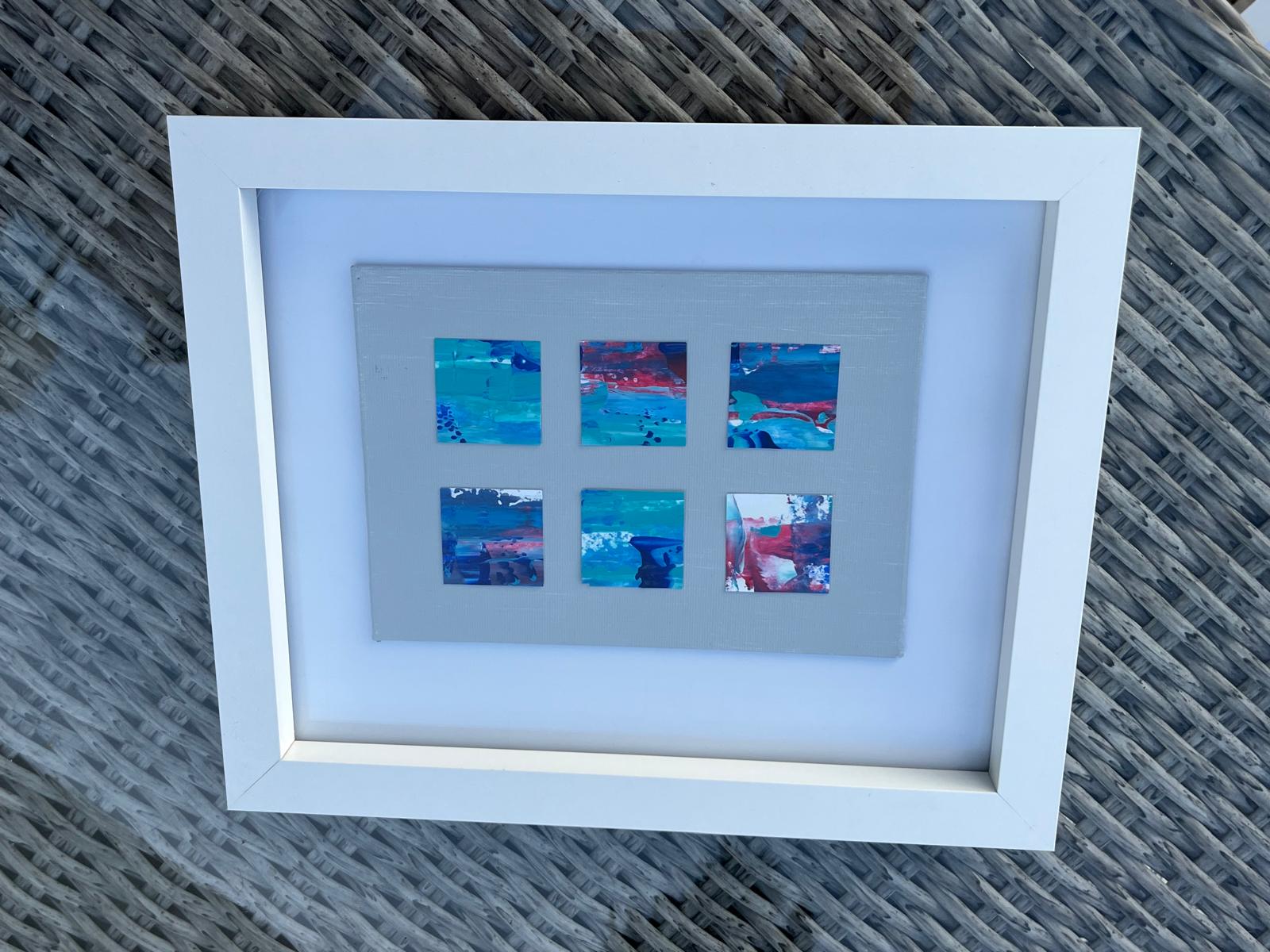 Black and gold abstract artworks displayed in matching frames